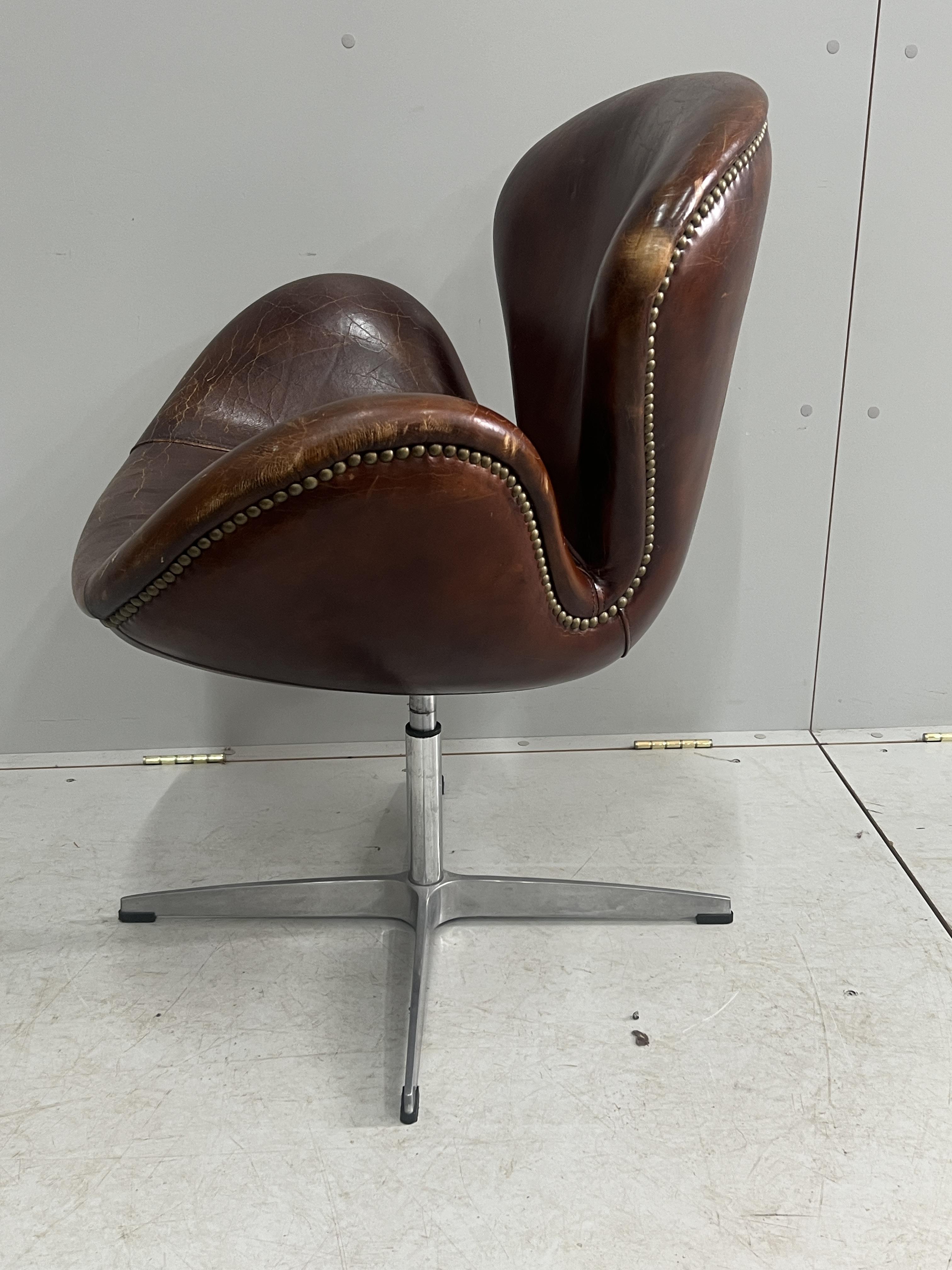 A tan leather petal chair, width 70cm, depth 42cm, height 84cm